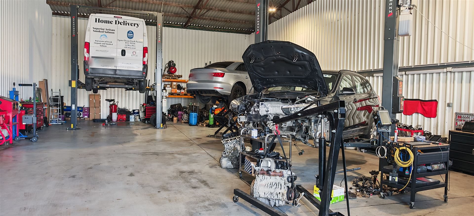 Delivery van and cars being serviced at Car Avenue workshop in Ashbourne