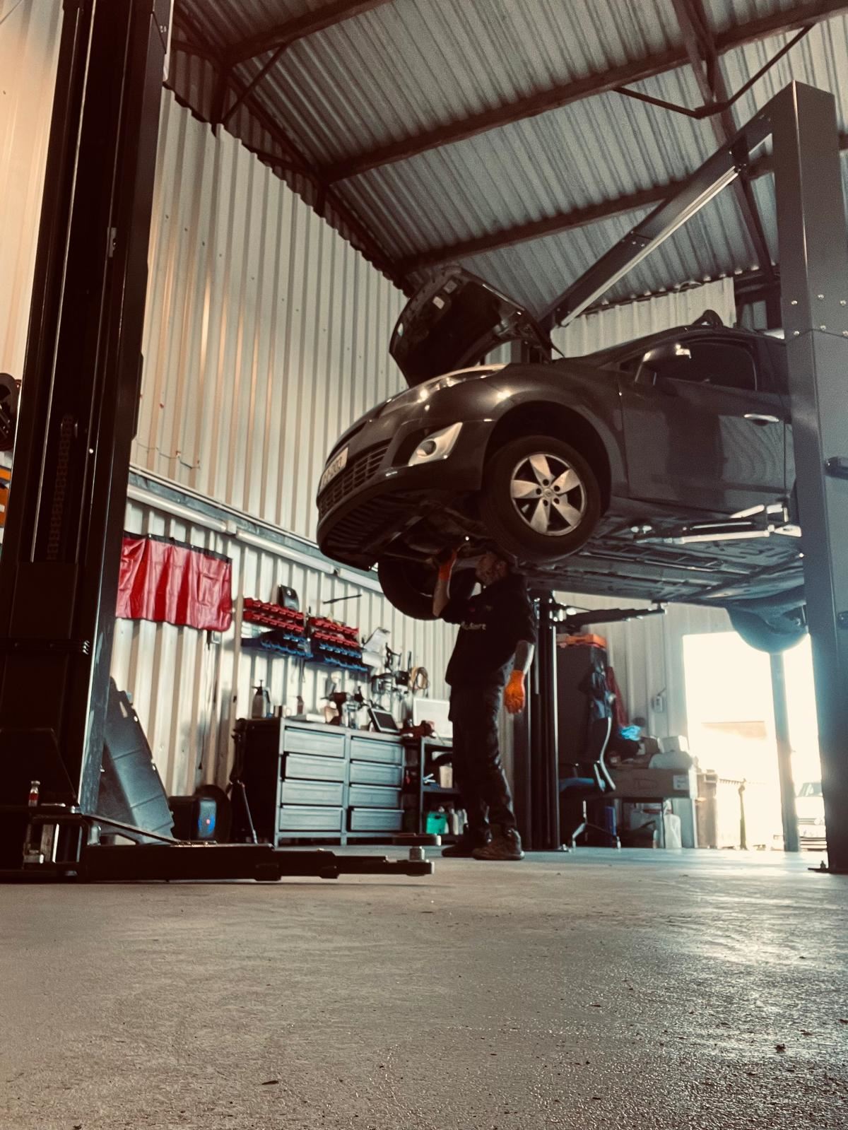 Vehicle underbody inspection on a lift at Car Avenue workshop in Ashbourne