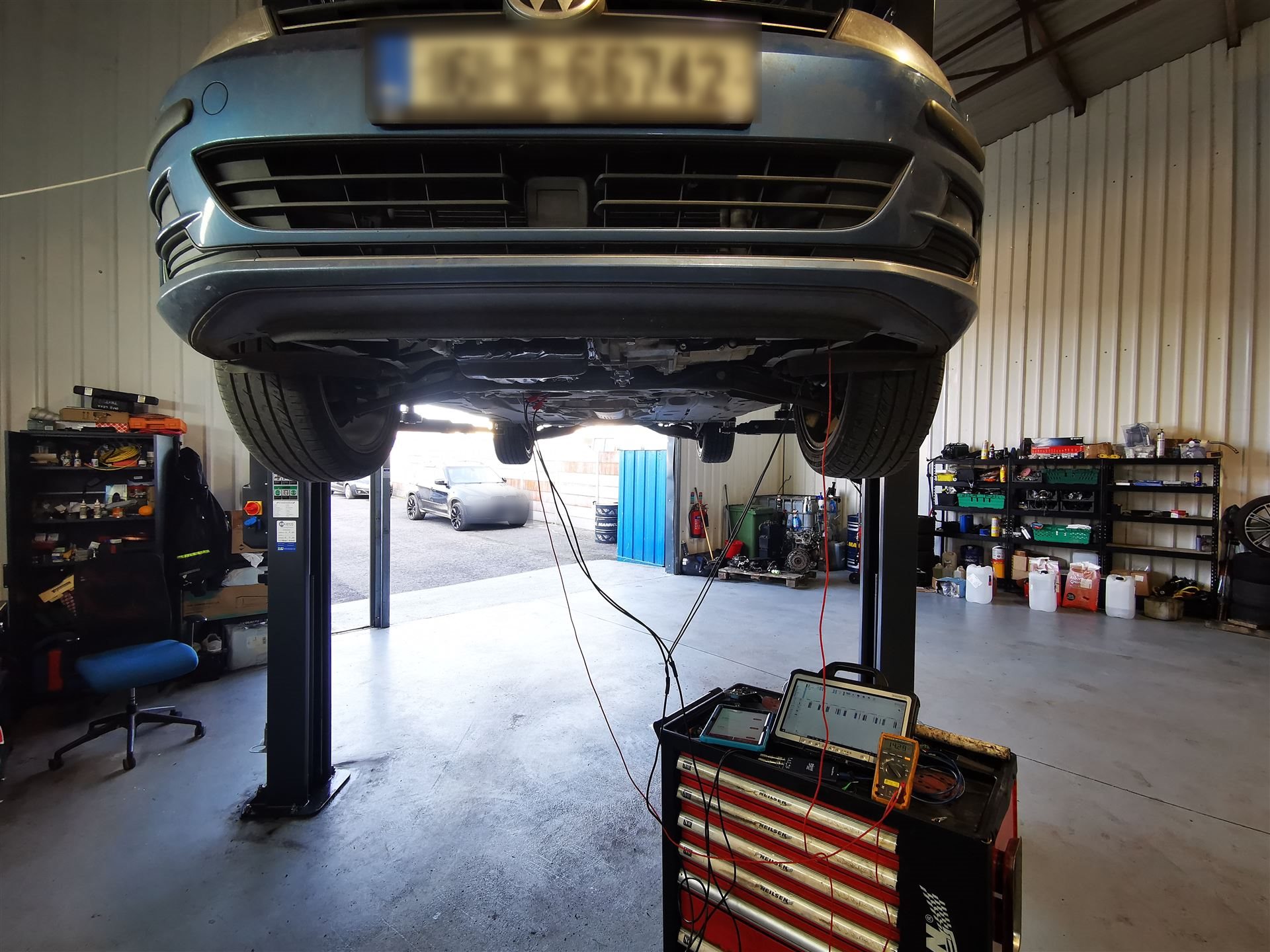 Volkswagen undergoing diagnostic testing on a lift at Car Avenue workshop in Ashbourne